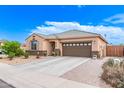 Inviting one-story home with a desert-landscaped front yard and a spacious driveway leading to a two-car garage at 729 W Silver Reef Dr, Casa Grande, AZ 85122