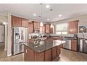 Modern kitchen featuring stainless steel appliances, granite countertops, and ample cabinet space at 729 W Silver Reef Dr, Casa Grande, AZ 85122