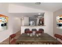 Open-concept dining room showcases eat-in counter and view to the kitchen, perfect for seamless entertaining at 7365 W Magdalena Ln, Laveen, AZ 85339