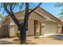 Exterior of a well-maintained home featuring a manicured lawn and inviting front entrance at 7365 W Magdalena Ln, Laveen, AZ 85339