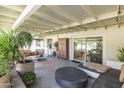 Comfortable covered back patio with stylish furniture, plants, and string lights for relaxing and entertaining at 7719 N 17Th Ave, Phoenix, AZ 85021