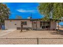Single story home featuring a low fence and gravel landscaping for easy maintenance at 7746 W Osborn Rd, Phoenix, AZ 85033