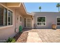 Welcoming front porch showcasing stylish pavers, desert landscaping, and a secured decorative front door at 10643 W Pineaire W Dr, Sun City, AZ 85351
