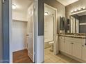 The well-lit bathroom boasts granite countertops, double sinks, and a shower/tub combo at 11026 N 28Th Dr # 34, Phoenix, AZ 85029