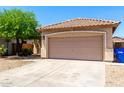 A single-Gathering home showing a two-car garage, desert landscaping, and tile roof at 11182 W Coronado Rd, Avondale, AZ 85392