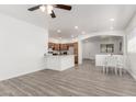 Open-concept living space with a view of the kitchen, dining area, and sleek, modern floors at 11182 W Coronado Rd, Avondale, AZ 85392