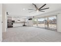 Open-concept living space flows into the kitchen and out to the patio through sliding glass doors at 12531 W Glenn Dr, Glendale, AZ 85307