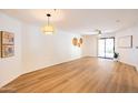 A bright living room featuring wood floors and a sliding glass door to the patio at 1287 N Alma School Rd # 171, Chandler, AZ 85224