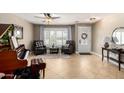 Beautifully appointed living room with tile flooring, piano, and an abundance of natural light at 1311 W Ellis St, Mesa, AZ 85201