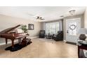 Elegant living room featuring tile flooring, a piano, and comfortable seating area at 1311 W Ellis St, Mesa, AZ 85201
