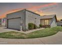 Home exterior featuring a detached garage, xeriscaping, and a well-maintained lawn at 13219 N 26Th Ave, Phoenix, AZ 85029