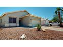 Well-maintained single-story home featuring desert landscaping, a two-car garage, and a side parking area at 16537 N Oachs Dr, Surprise, AZ 85374