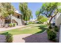 Scenic courtyard featuring lush landscaping, green lawns, and walking paths at 1825 W Ray Rd # 1070, Chandler, AZ 85224