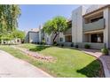 Exterior view of multi-story apartments with well-maintained lawn and mature trees at 1825 W Ray Rd # 1070, Chandler, AZ 85224