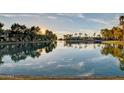 Picturesque lake view reflecting the sky, trees, and waterfront buildings at 1825 W Ray Rd # 1070, Chandler, AZ 85224