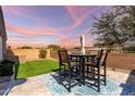 Inviting backyard patio with seating, a lush lawn, and a privacy fence, perfect for outdoor entertaining at 2023 W Yellowbird Ln, Phoenix, AZ 85085