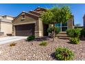 Single-story home featuring desert landscaping with vibrant plants and a two-car garage at 2023 W Yellowbird Ln, Phoenix, AZ 85085