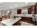 Kitchen featuring granite countertops, stainless steel appliances, and an island with seating at 2023 W Yellowbird Ln, Phoenix, AZ 85085