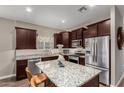Spacious kitchen features granite countertops, stainless steel appliances, and a center island at 2023 W Yellowbird Ln, Phoenix, AZ 85085