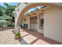 Charming front porch with a brick floor, stone supports, and a decorative archway for an inviting entrance at 2125 E Elmwood St, Mesa, AZ 85213