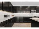Gourmet kitchen featuring sleek cabinetry, stainless steel appliances, subway tile backsplash, and ample counter space at 22938 E Calle Luna --, Queen Creek, AZ 85142