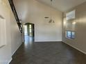 Spacious living room with tile floors, high ceilings, and staircase at 24919 W Illini St, Buckeye, AZ 85326