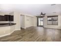 Sunlit living space featuring hardwood floors, modern light fixtures, and sliding glass doors to the patio at 3558 E Windsor Dr, Gilbert, AZ 85296
