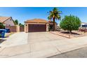 Charming single-story home featuring a well-maintained yard, desert landscaping, and a spacious driveway at 3608 W Morelos St, Chandler, AZ 85226