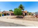Charming single-story home with desert landscaping, spacious driveway, and mature trees in a well-kept neighborhood at 3608 W Morelos St, Chandler, AZ 85226