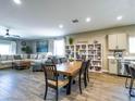 Open-concept living and dining area with tile flooring and a view into the modern kitchen at 37008 N Aleutian Dr, San Tan Valley, AZ 85143