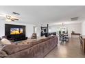 Open-concept living room and kitchen featuring wood floors and a large TV at 4613 S Rita Ln, Tempe, AZ 85282