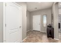 The entryway features tile flooring, neutral paint and a window for natural light at 5312 S 33Rd Ave, Phoenix, AZ 85041