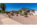 Well-maintained front yard featuring desert landscaping and charming curb appeal on a sunny day at 554 N Sunset Dr, Chandler, AZ 85225