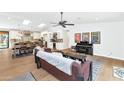 Open-concept living area with wood floors, skylights, and a view into the modern kitchen at 5612 E Emile Zola Ave, Scottsdale, AZ 85254