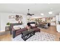 Bright and airy living room with wood floors and seamless access to the dining and kitchen areas at 5612 E Emile Zola Ave, Scottsdale, AZ 85254