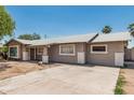 Single-story home with a neutral stucco exterior, well-defined windows and trim, with a front yard at 6334 N 37Th Ave, Phoenix, AZ 85019