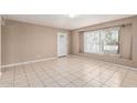 Bright living room featuring tile flooring, a white front door, and a sunny window at 6334 N 37Th Ave, Phoenix, AZ 85019