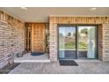 Inviting entryway with wood door, brick accents, and large window, creating a warm and welcoming ambiance at 7037 N 11Th Dr, Phoenix, AZ 85021