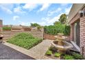 Tranquil outdoor patio with a tiered fountain and well-maintained landscaping, perfect for relaxation at 7037 N 11Th Dr, Phoenix, AZ 85021