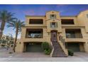 Stunning three-story home featuring multiple balconies, arched windows, and a well-manicured lawn at 7122 W Ivanhoe St, Chandler, AZ 85226