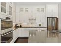 Modern kitchen featuring white cabinetry, stainless steel appliances, and sleek countertops at 7122 W Ivanhoe St, Chandler, AZ 85226