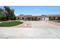 Single-story home featuring a spacious driveway and low-maintenance desert landscaping at 730 W Curry St, Chandler, AZ 85225