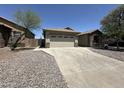 Charming single story home featuring a two-car garage, desert landscaping, and well maintained driveway at 7419 S 45Th Ave, Laveen, AZ 85339