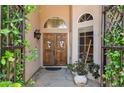 Inviting double front doors framed by lush greenery create a warm entrance to this home at 758 S Lagoon Dr, Gilbert, AZ 85233