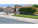 Lush green lawn and manicured bushes accent this home's beautiful desert landscaping at 758 S Lagoon Dr, Gilbert, AZ 85233