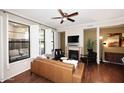Spacious living room with large windows, decorative fireplace and hardwood floors at 7601 E Indian Bend Rd # 1040, Scottsdale, AZ 85250