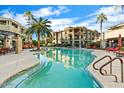 Beautiful community pool with crystal clear water and poolside seating surrounded by lush landscaping at 7601 E Indian Bend Rd # 1040, Scottsdale, AZ 85250