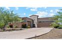 Beautiful stucco home with a stone facade, well-maintained landscaping, and a paver driveway at 8396 E Granite Pass Rd, Scottsdale, AZ 85266