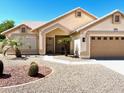 Charming single-story home with desert landscaping, a two-car garage, and a welcoming front entrance at 9109 W Watson Ln, Peoria, AZ 85381