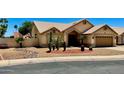 Single-story home with well-manicured desert landscaping and an attached two-car garage at 9109 W Watson Ln, Peoria, AZ 85381